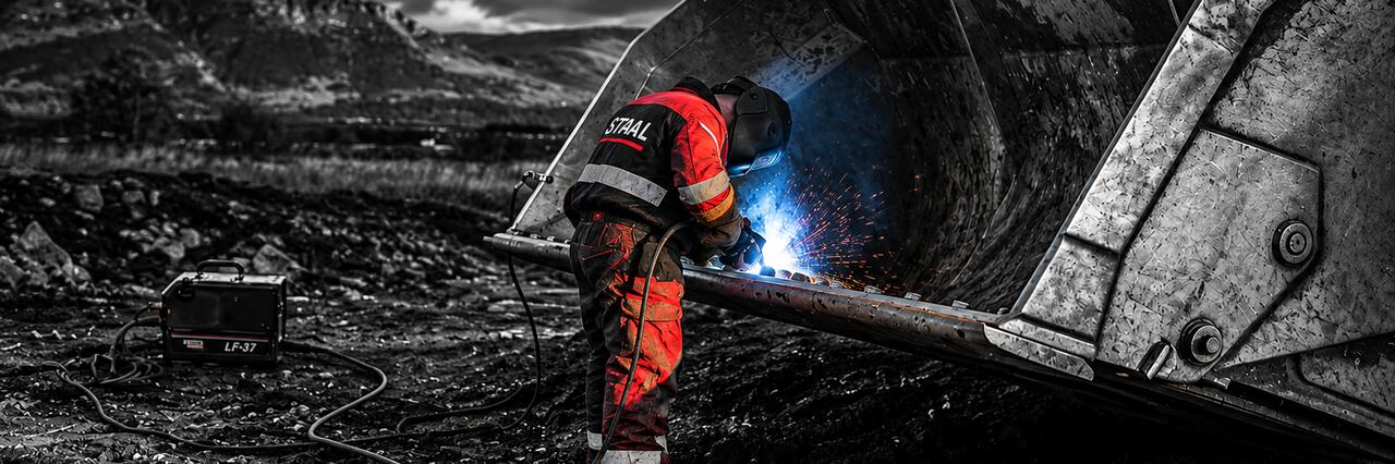 STAAL technician welding the repair of a mining bucket